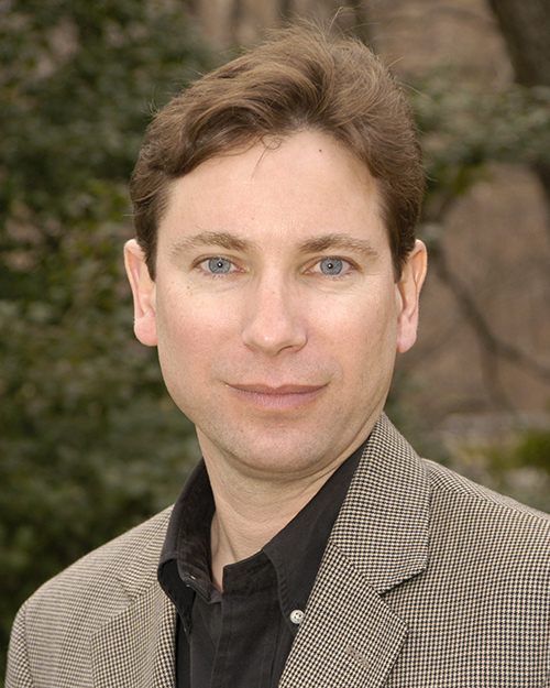 a man in a suit and tie posing for a picture