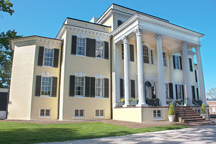 a large white house with black shutters on the front