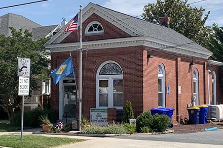 a red brick building with a flag on top of it