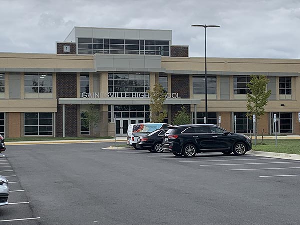 a parking lot with cars parked in front of a building