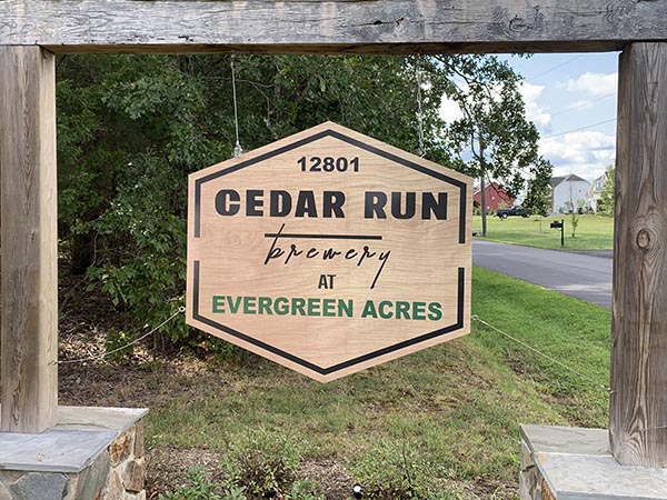 a wooden sign that reads cedar run brewery