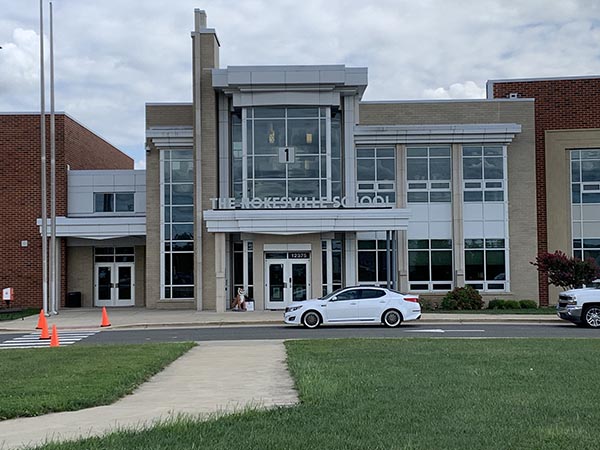 a white car parked in front of a building
