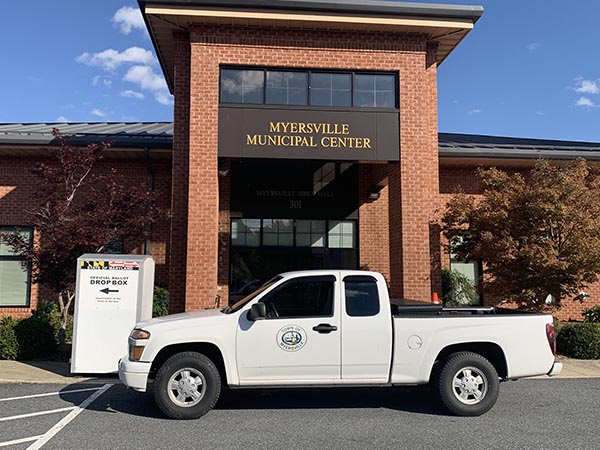 a white truck parked in front of a building